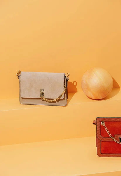 Vintage clutch bag on yellow shelf in the store space. Minimal still life scene. Sale and shopping trendy concept