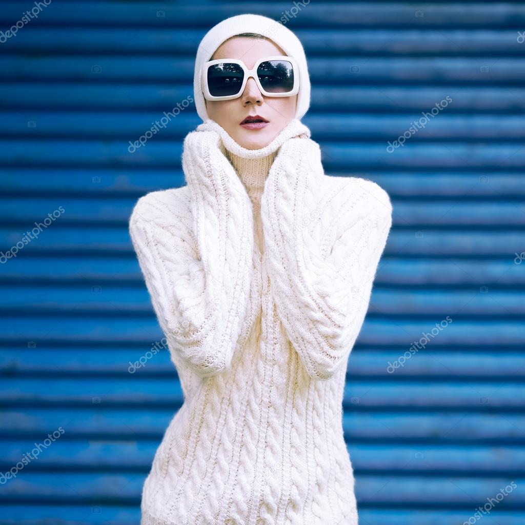 Portrait stylish autumn lady in white glamorous clothes on a blue background