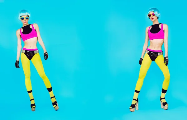 Glamorous fashion dj girl in bright clothes on a blue background — Stock Photo, Image
