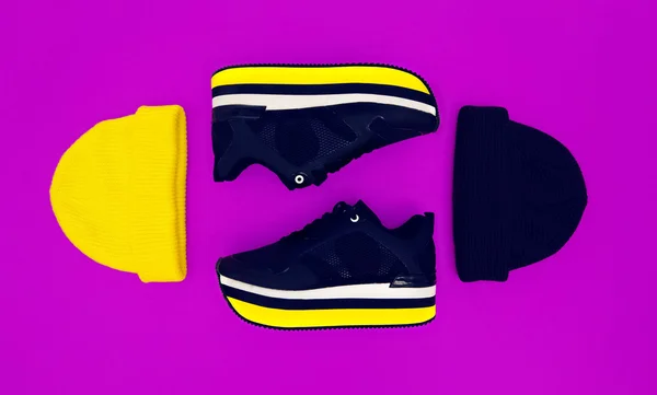 Stilfulde piger mode tilbehør hatte og sneakers på en violet - Stock-foto