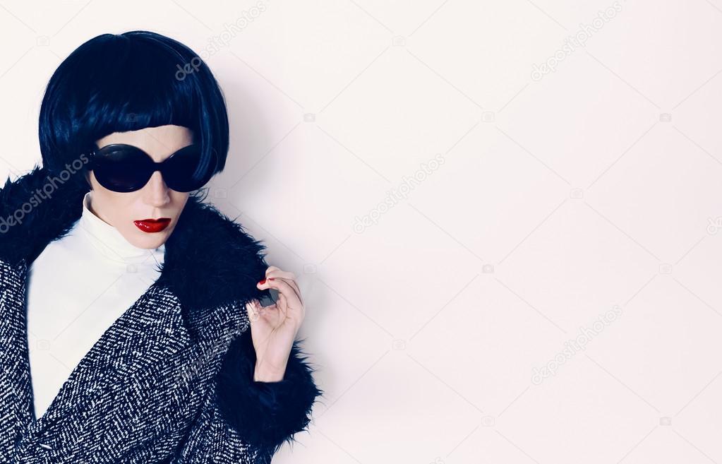 Brunette model in fashionable coat on a white background