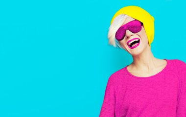 şık bir şapka ve güneş gözlüğü üzerinde parlak bac ile mutlu sarışın