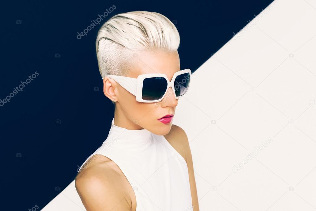 Blonde model in trendy sunglasses with stylish Haircut. Fashion