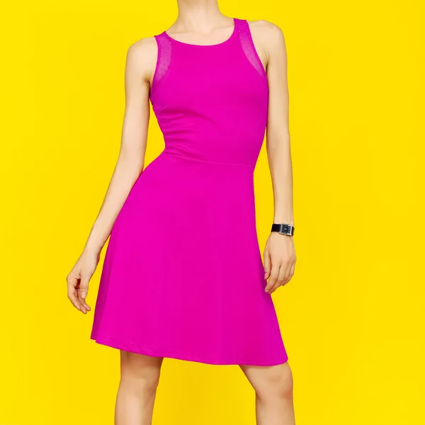 Girl in bright pink summer dress on yellow background — Stock Photo, Image