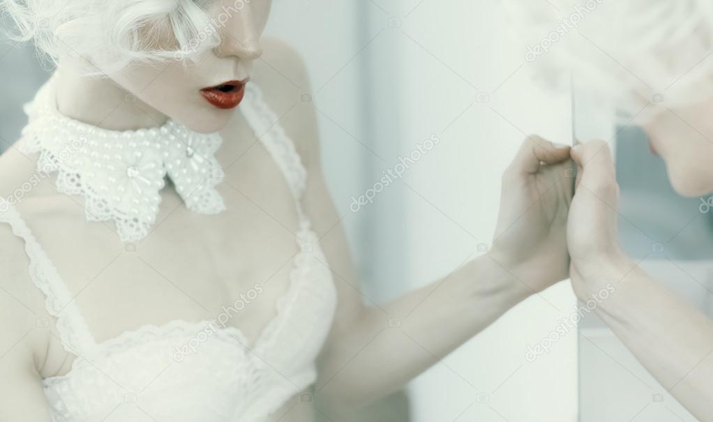 Sensual blond woman in white interior. Underwear. Luxury style.