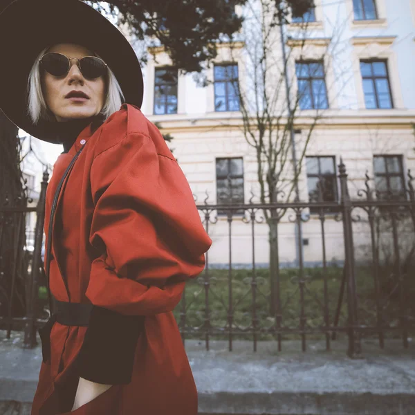 sensual blond woman in vintage clothing on the city street