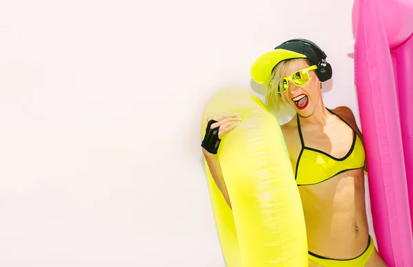model DJ with inflatable mattress against the wall. Summer hot p
