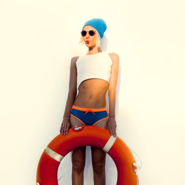 Funny blonde on wall background with lifebuoy