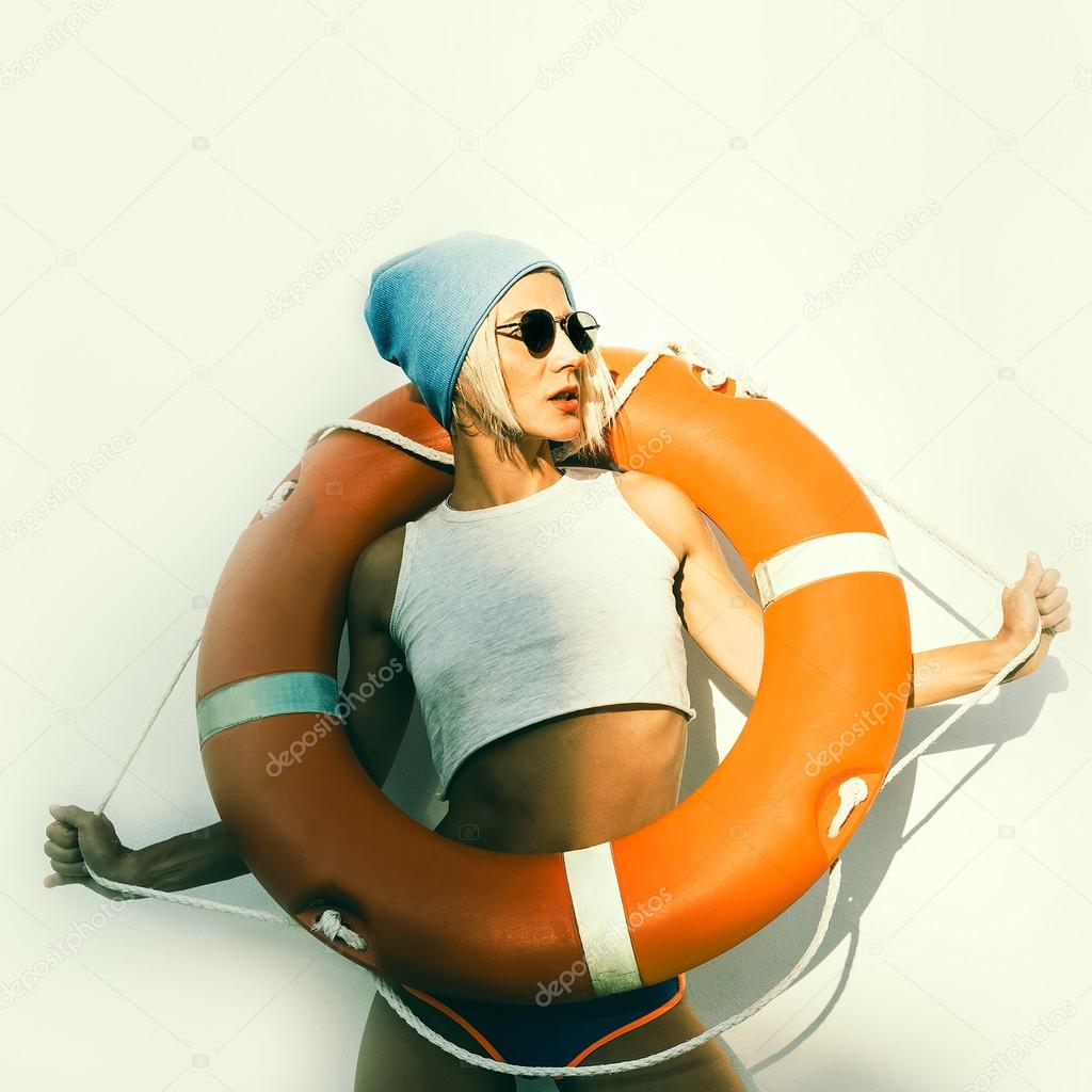 Stylish lady with life buoy. Fashion maritime style