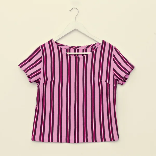 Fashionable striped shirt on hanger on white background — Stock Photo, Image