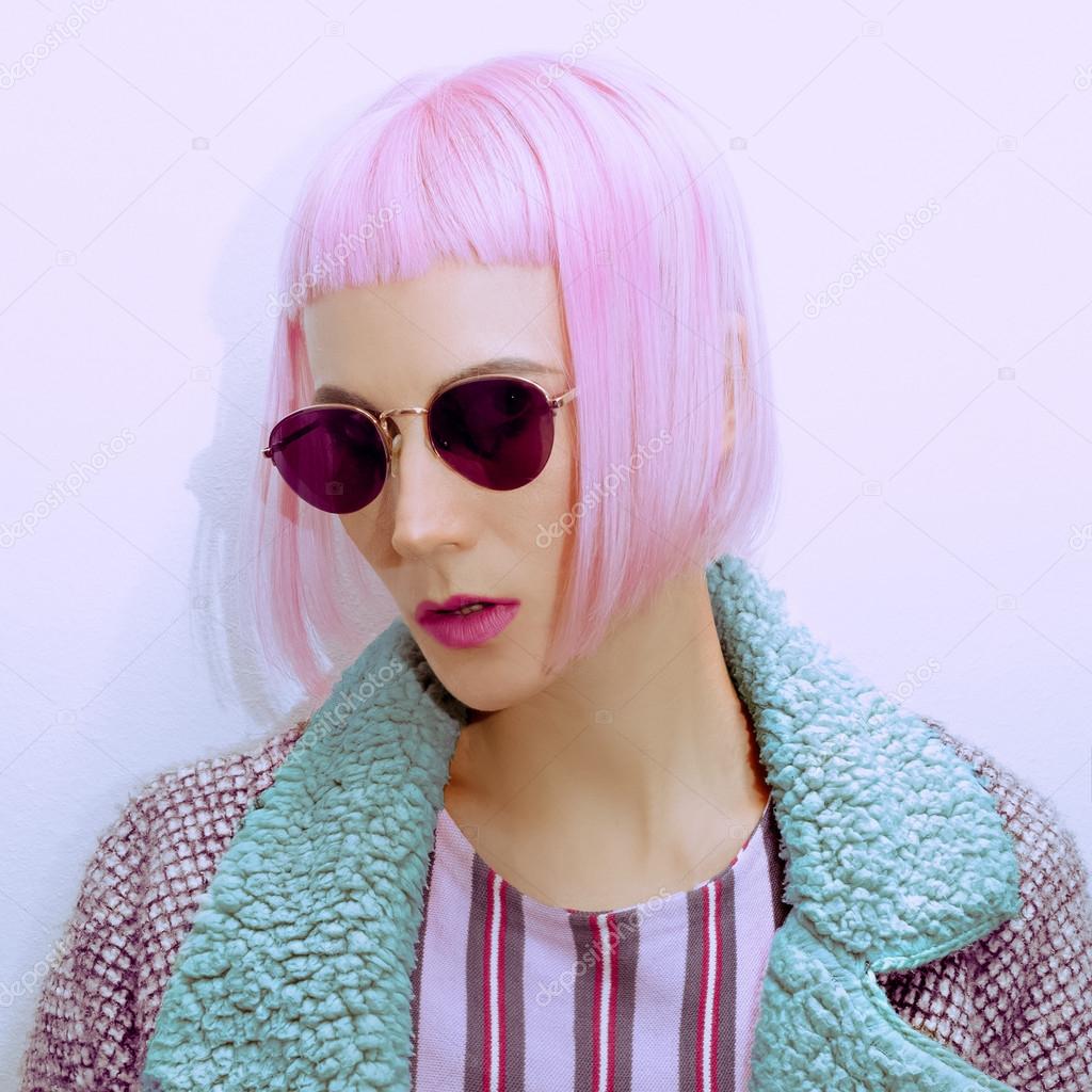 Fashion girl in vintage sunglasses and trendy haircut