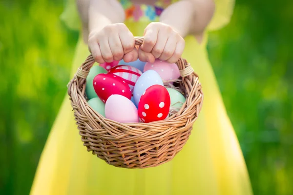 Child holding basket with Easter eggs — Stock Photo, Image