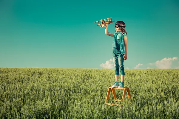 Glückliches Kind spielt mit Spielzeugflugzeug — Stockfoto