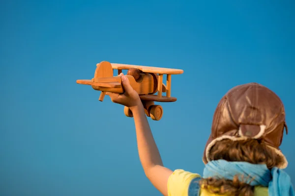 Happy kid playing with airplane outdoors — Stock Photo, Image