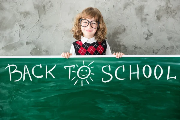 Child in class holding board — Stock Photo, Image