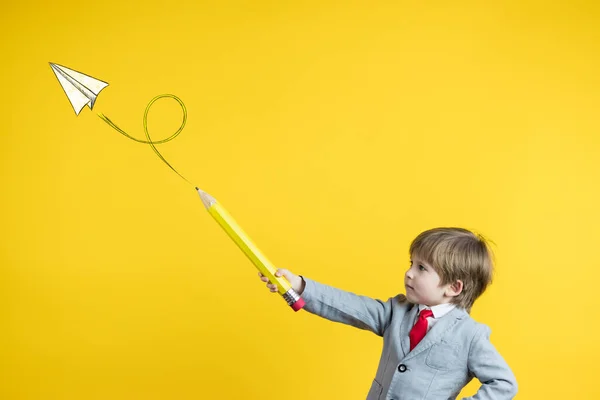 Criança Feliz Segurando Lápis Contra Fundo Amarelo Criação Empresas Conceito — Fotografia de Stock