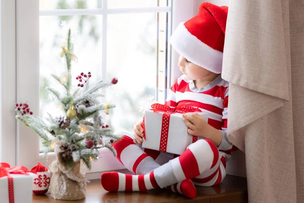 Child Sitting Windowsill Happy Kid Wearing Christmas Pajamas Child Holding — Stock Photo, Image