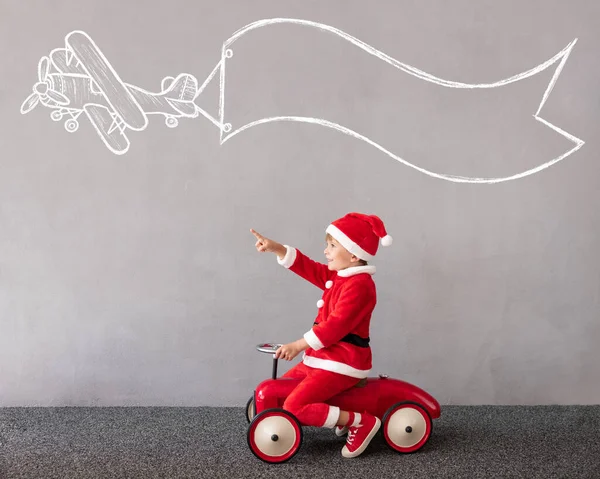 Happy Child Wearing Christmas Costume Kid Riding Toy Car Funny — Stock Photo, Image