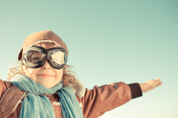 Happy child playing with toy airplane