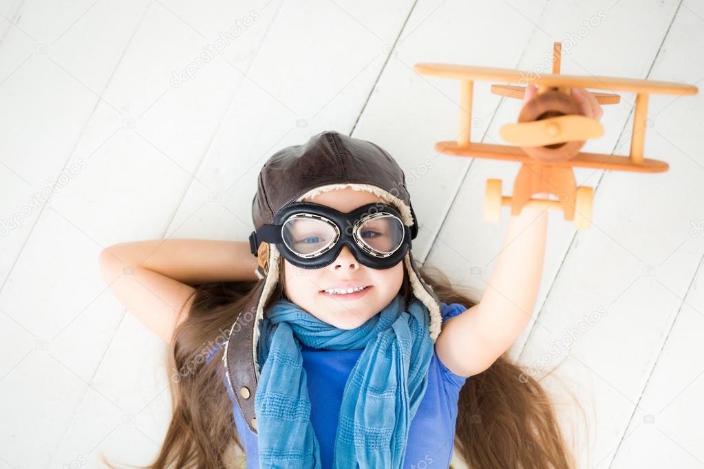 Happy child playing with toy airplane
