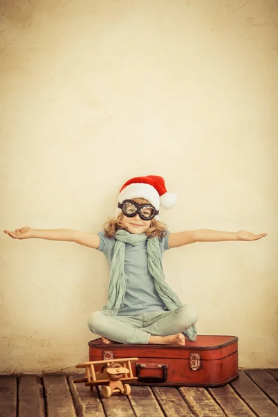 Happy child playing with toy airplane — Stock Photo, Image