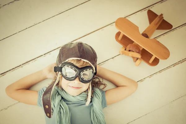 Happy child playing with toy airplane — Stock Photo, Image