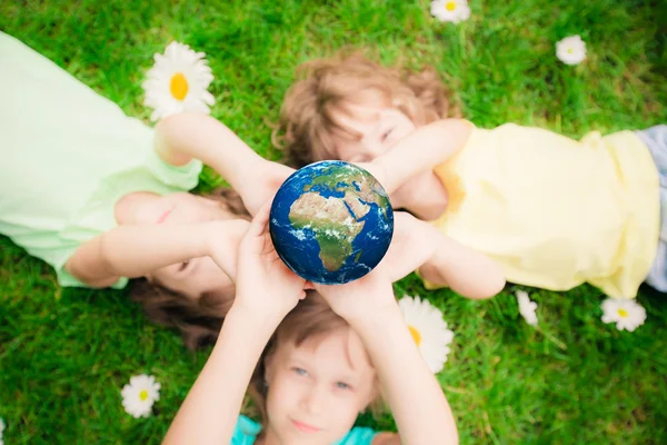 Children holding Earth planet — Stock Photo, Image