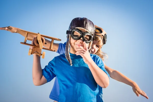 Children playing with toy airplane — Stock Photo, Image