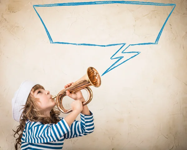 Child blowing  nautical horn — Stock Photo, Image
