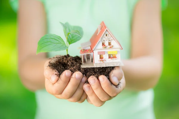 Child holding house and tree — Stock Photo, Image