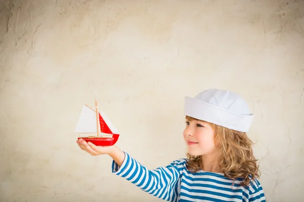 Child playing with  toy ship — Stock Photo, Image