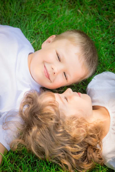 Children lying on grass — Stock Photo, Image