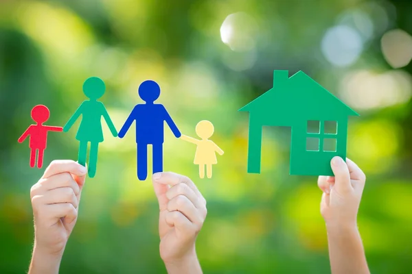 Paper house and family in hand — Stock Photo, Image