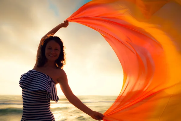 Silhouet van jonge vrouw springen in de beach — Stockfoto