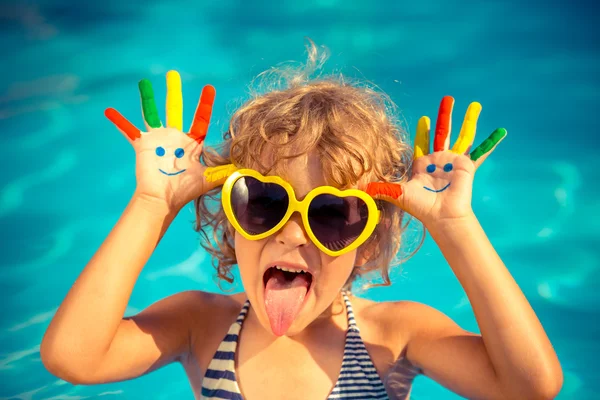 Child with drawing smiley on hands — Stock Photo, Image