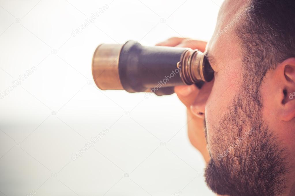 Man looking through the binoculars