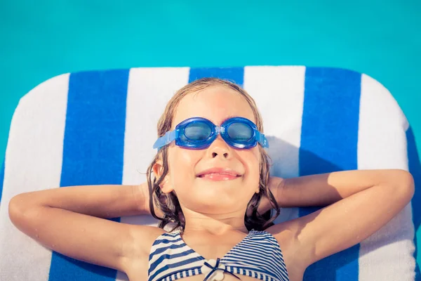 Funny child lying on beach bed — Stock Photo, Image