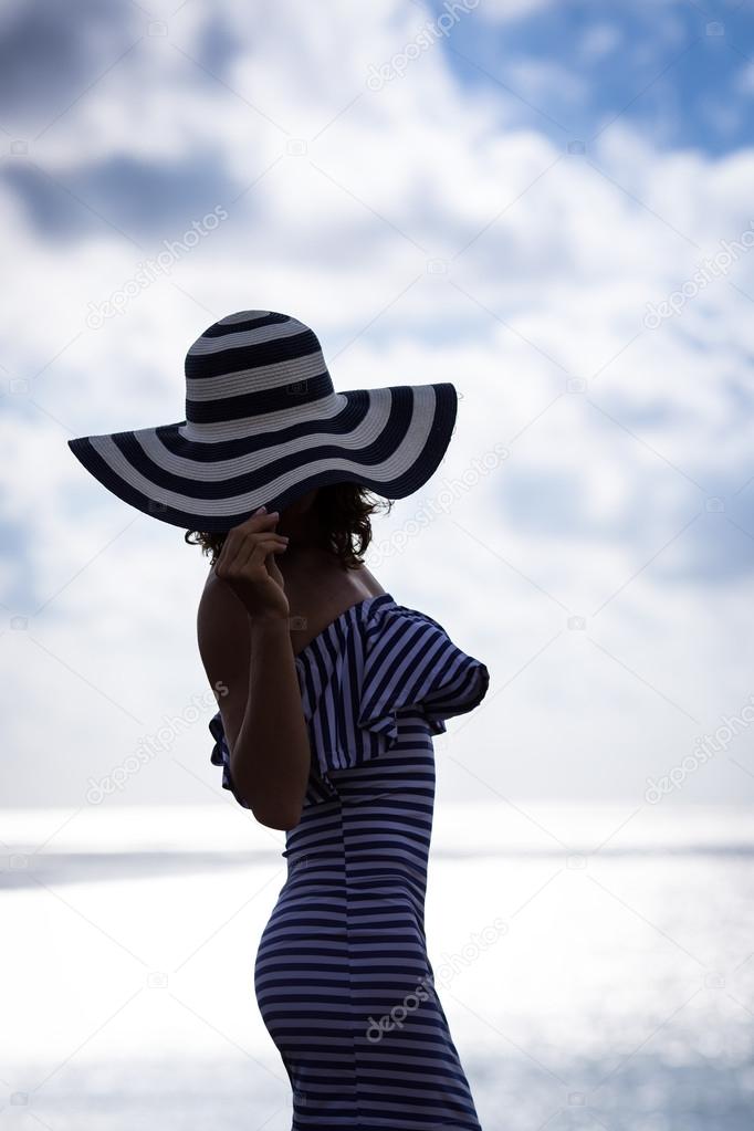 Silhouette of young woman relaxing at the beach