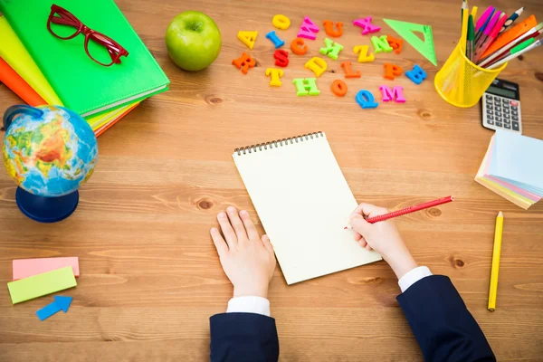 Child writing in copybook — Stock Photo, Image