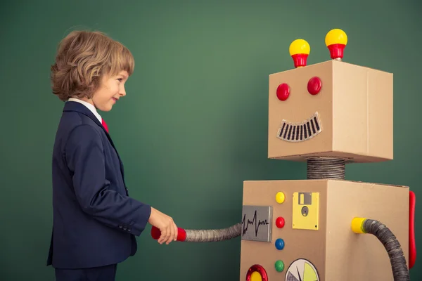 Kid with toy robot in school — Stock Photo, Image