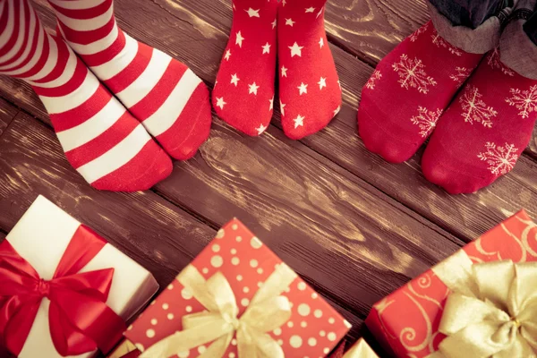 Feet of family with Christmas gifts — Stock Photo, Image