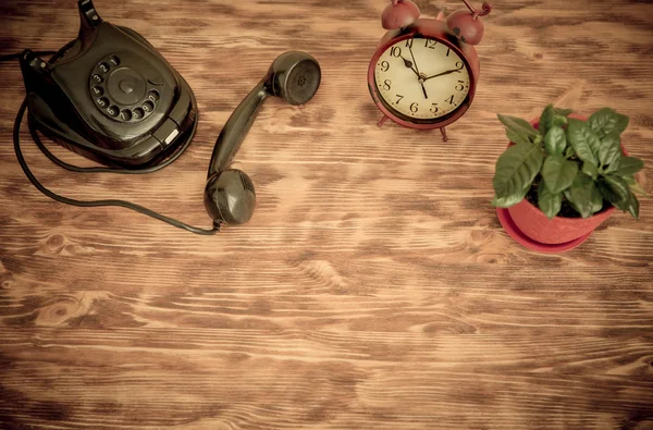 Phone  with alarm clock and flowerpot — Stock Photo, Image