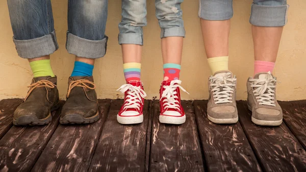 Family legs in shoes with different socks — Stock Photo, Image