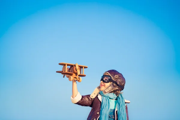 Happy child playing with toy airplane — Stock Photo, Image