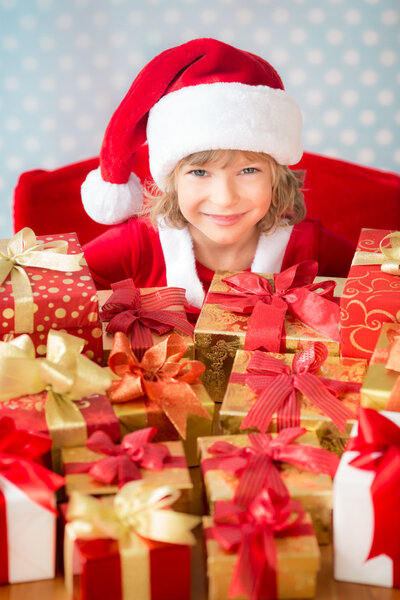 Child holding Christmas gift boxes