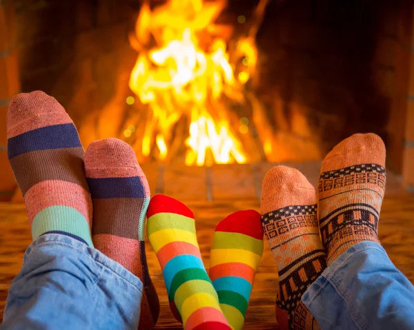 Family near fireplace — Stock Photo, Image