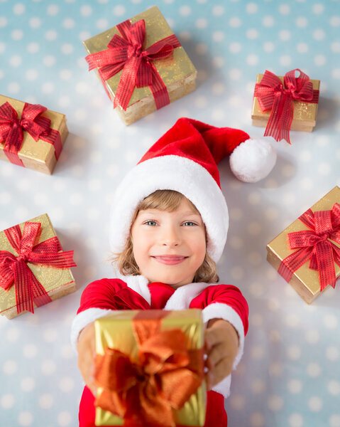 Child with Christmas gif boxes