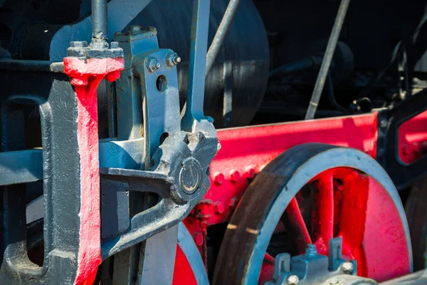 Closeup view of steam locomotive wheels, drives, rods, links and