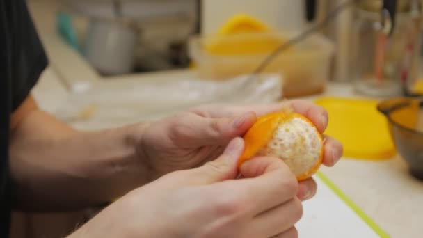 Man Peels Eats Mandarin — Stock Video