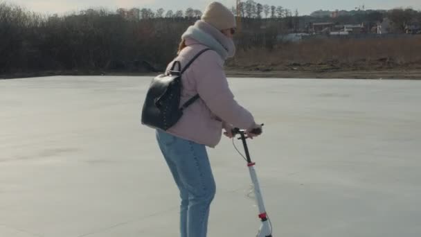 Vrouw op scooter op speelplaats — Stockvideo